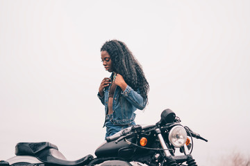 African woman together a custom motorcycle.