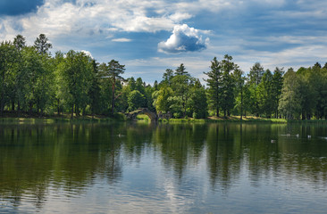 Fototapeta na wymiar Summer panoramic landscape on the lake with old bridge. Gatchina. Russia