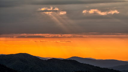 A wonderful sunset in the mountains. Orange sky and dark silhouettes of mountains. Carpathian Mountains landscape. Bieszczady. Poland