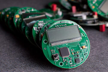 round electronic boards with display, microchip and processor, many meter components