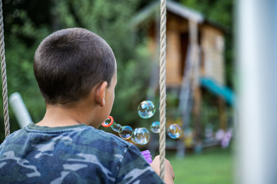 Boy blowing soap bubbles