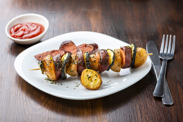 Potato skewers with sausage and zucchini