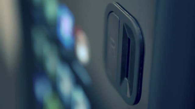 Inserting one euro coin into vending machine