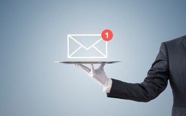Businessman holding new email graphic illustration on silver tray 