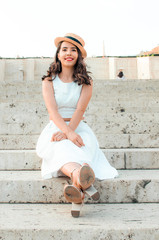 candid woman in white dress sitting,street style