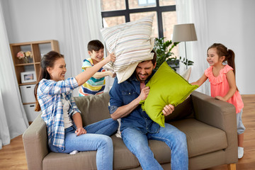 family, childhood and people concept - happy father, mother, little son and daughter fighting by...