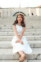 candid woman in white dress sitting,street style