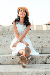 candid woman in white dress sitting,street style