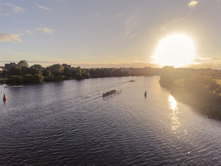 Eight shell practice, River Corrib, Galway city, Ireland, Sunset, muted colors. Aerial view. calm...