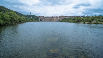 View of a river dam and bridge from the middle of the river
