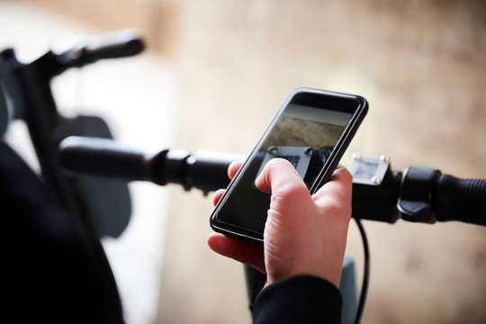 Cropped image of teenage girl using mobile phone over electric push scooter