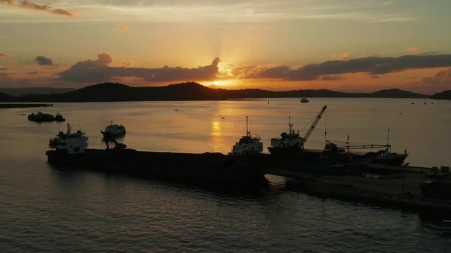 Sunset over the bay with the seaport and ships on the island of Siargao, Philippines. Dapa Ferry Terminal.