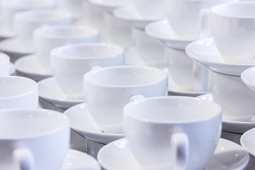 Many empty white cups in a cafe