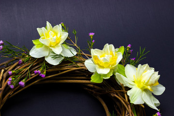 wreath decorated with daffodils on a dark background