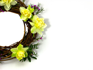 wreath decorated with daffodils on a white background