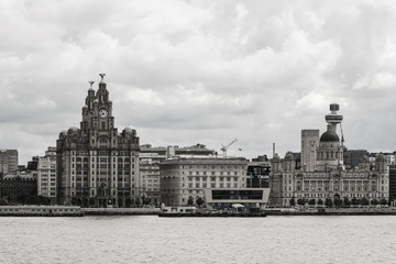 Fototapeta premium Liverpool seafront view from ferry in a summer cloudy day with the royal liver building imposing 