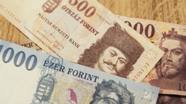 You can see a lot of different withdrawn Hungarian Forint banknotes, getting thrown on the table. 4K Video