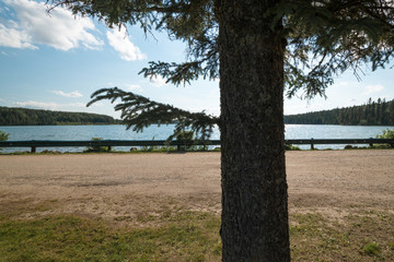 a cloudy day sea beach picture with a clear reflection of clouds in water and beach stones in the foreground makes it look stunning cool beach picture