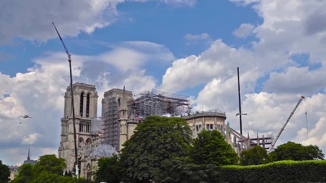 Paris, France - July 11 2019: French military aircrafts (awacs) flying over Notre Dame de Paris during reinforcement work after the fire. This is a preparation fly for Bastille Day Parade.