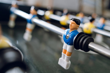 Close up on players of Table football soccer kicker foosball top-table game