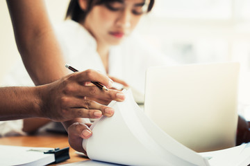 Co working team meeting concept: Asian Business people work and studying together with document notebook and papers in modern office, discuss finance /marketing solution reporting file in busy offices