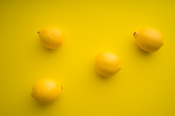 Lemon on yellow paper background