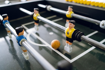 Close up on players of Table football soccer kicker foosball top-table game playing - obrazy, fototapety, plakaty