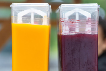 containers for filling with red and orange juice