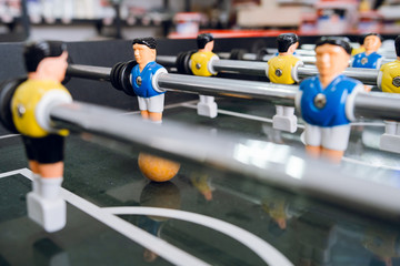 Close up on players of Table football soccer kicker foosball top-table game playing