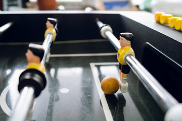 Close up on players of Table football soccer kicker foosball top-table game playing
