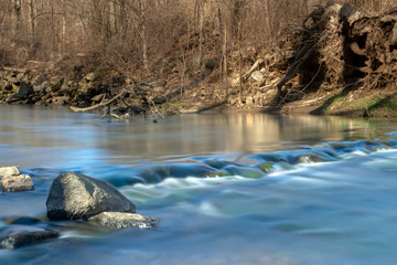 Long exposure of cool clear water running down a small river in Upstate New York