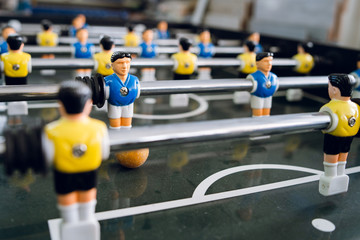 Close up on players of Table football soccer kicker foosball top-table game playing