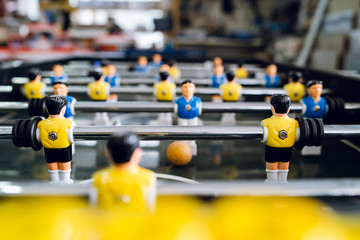 Obraz premium Close up on players of Table football soccer kicker foosball top-table game playing