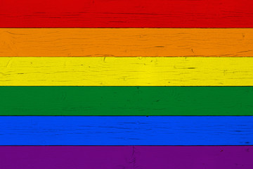 Rainbow flag on wooden background