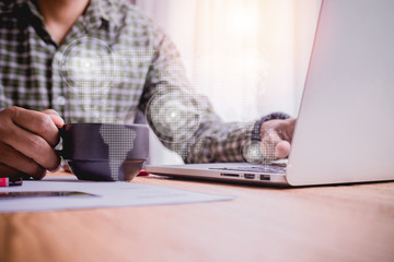 wood table with businessman drinking hot coffee with virtual world map.