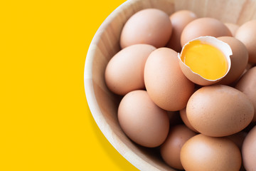 eggs and egg yolk on the yellow background.