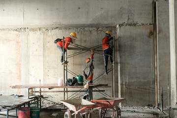 building construction teamwork. Tree labors working in the construction site with teamwork. 