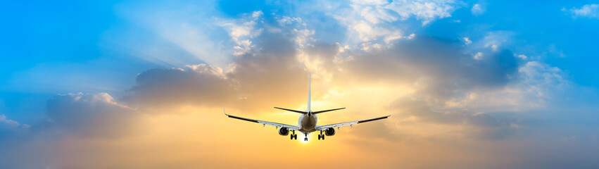 Airplane in the sky at sunrise © ABCDstock