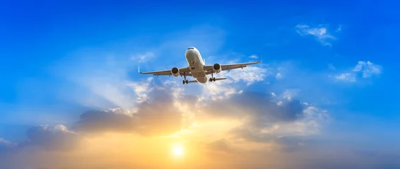 Fotobehang Vliegtuig Airplane in the sky at sunrise  © ABCDstock