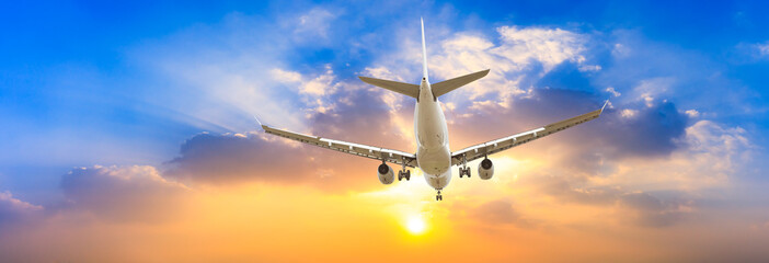 Airplane in the sky at sunrise © ABCDstock