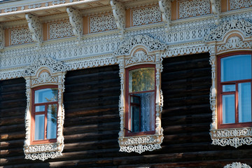 Tomsk Russia, traditional white lace windows decorating wooden home