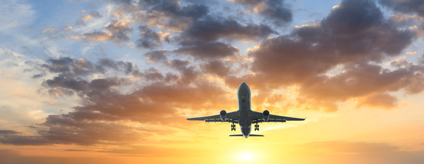 Airplane in the sky at sunrise