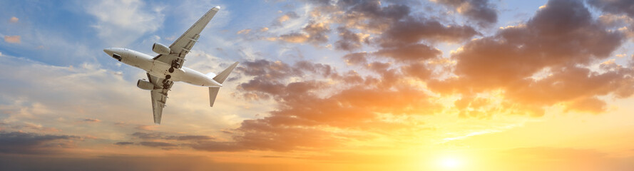 Airplane in the sky at sunrise