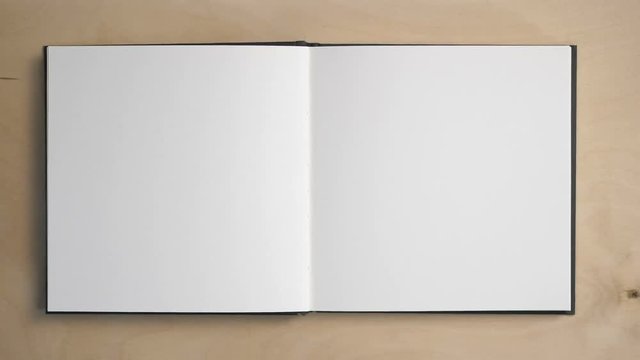 Opening a notebook. Blank pages to insert text and subtitles. The male hand flips over the pages, a pencil that has been thwarted. Cool for the background or the beginning of the movie.