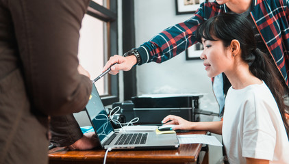 Woman staff being trained by supervisor in office