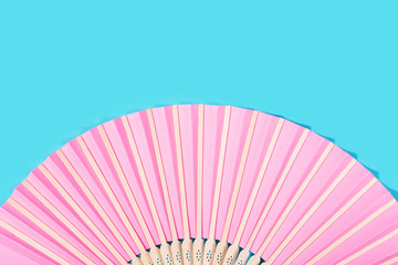 Beautiful pink fan on turquoise background.