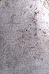 Background texture of old painted gray surface with scratches and stains. Close-up, vertical, top view, no people, free space. Concept of design.