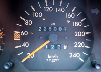 The console of a car that show speedometer and mileage.