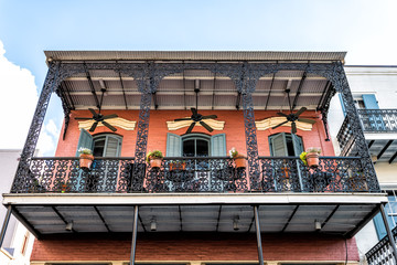 New Orleans, USA French quarter with wrought cast iron balcony of building in traditional...