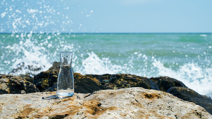 Glass bulb. Sea shore. Waves hit the stones.